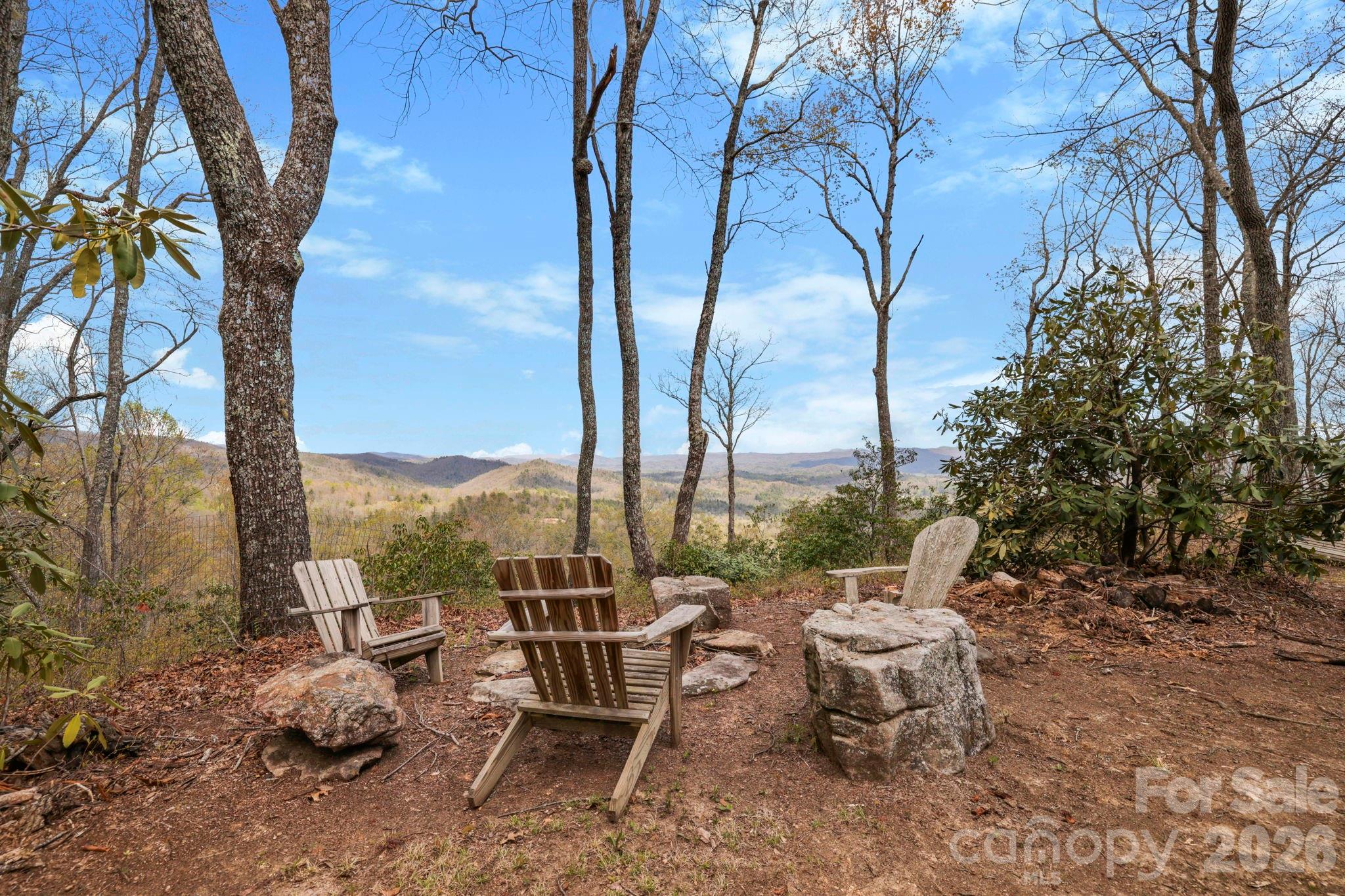 305 Stamey Creek Road Brevard, NC 28712 - Photo 4 of 32 a view of a patio with a table chairs and a fire pit