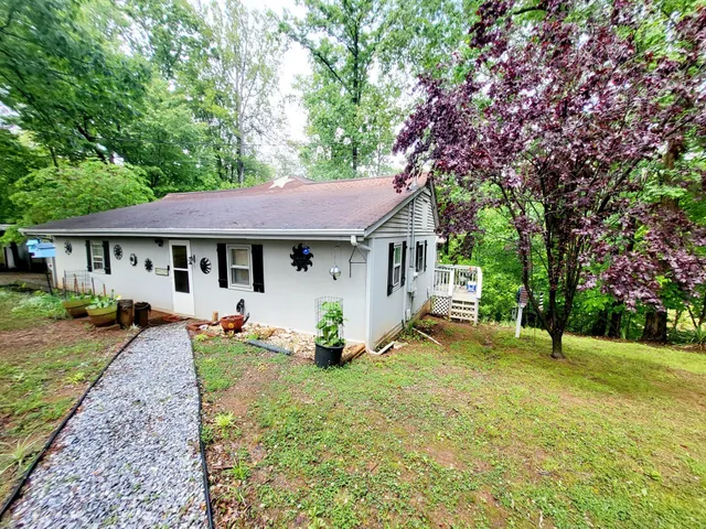 a front view of a house with a yard porch and furniture