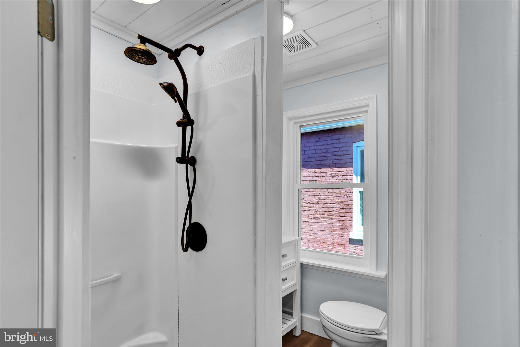 513 Manor Street Lancaster, PA 17603 - Photo 21 of 37 a bathroom with a shower a toilet and a window