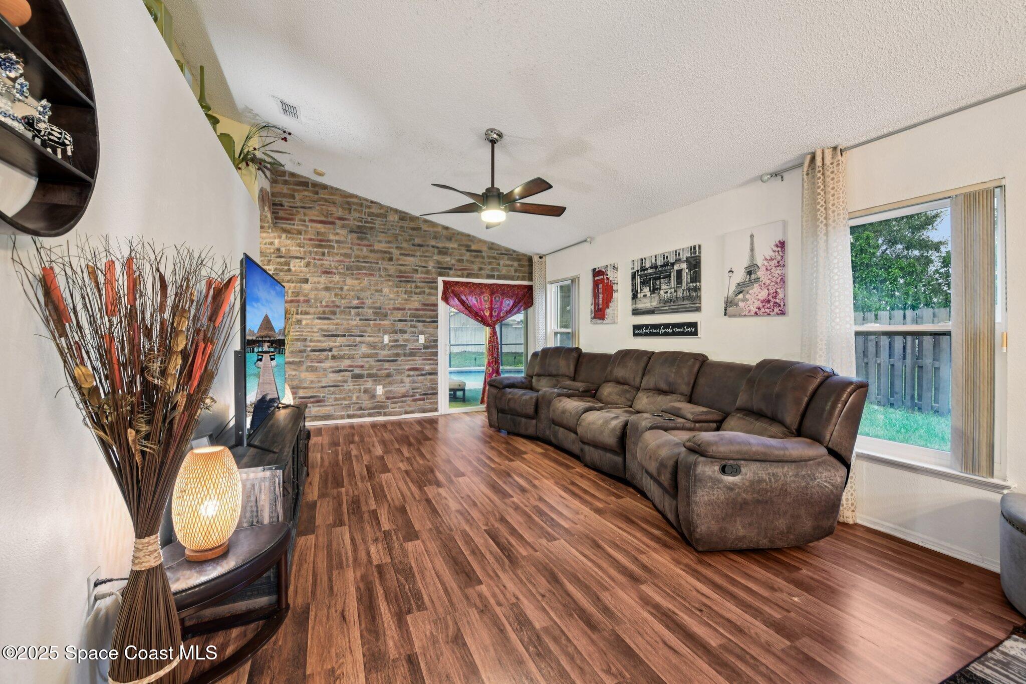 1125 Carey Glen Circle Orlando, FL 32824 - Photo 11 of 31 a living room with furniture and a wooden floor