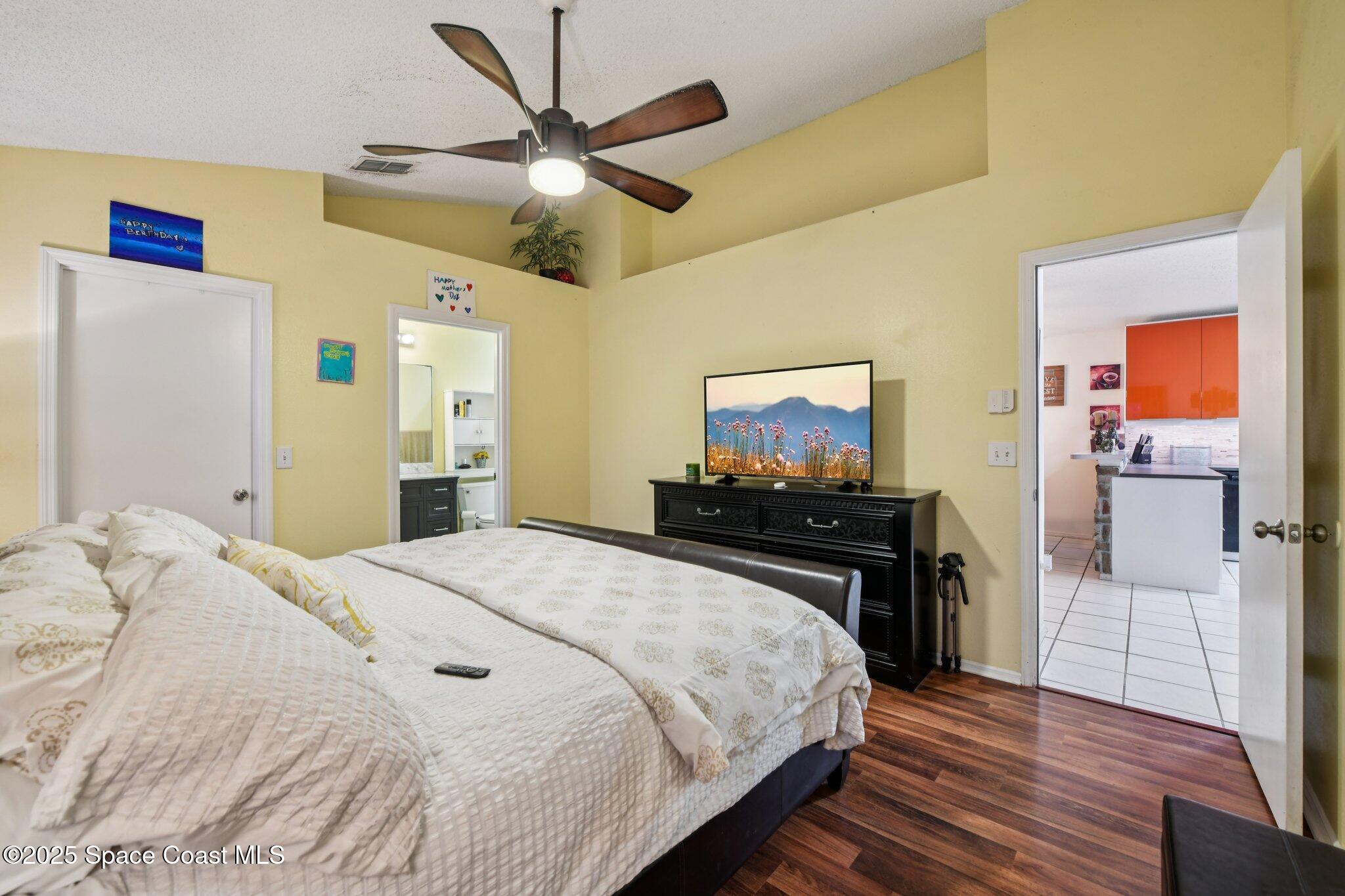 1125 Carey Glen Circle Orlando, FL 32824 - Photo 15 of 31 a bedroom with a bed and a flat screen tv