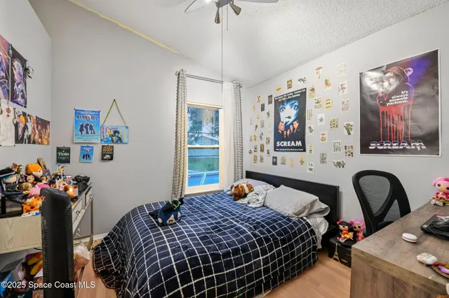 a bedroom with bed and large windows
