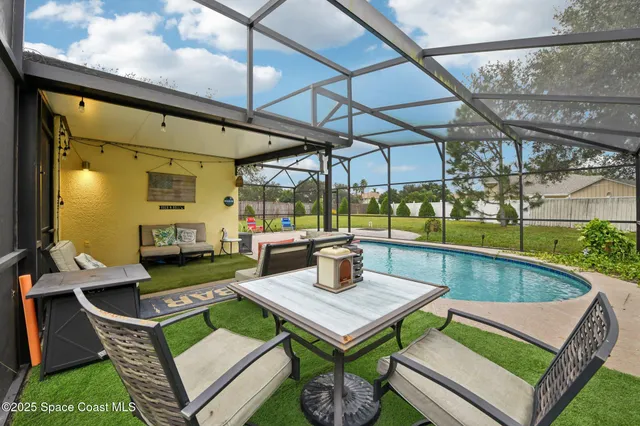 a view of a patio with table and chairs and potted plants