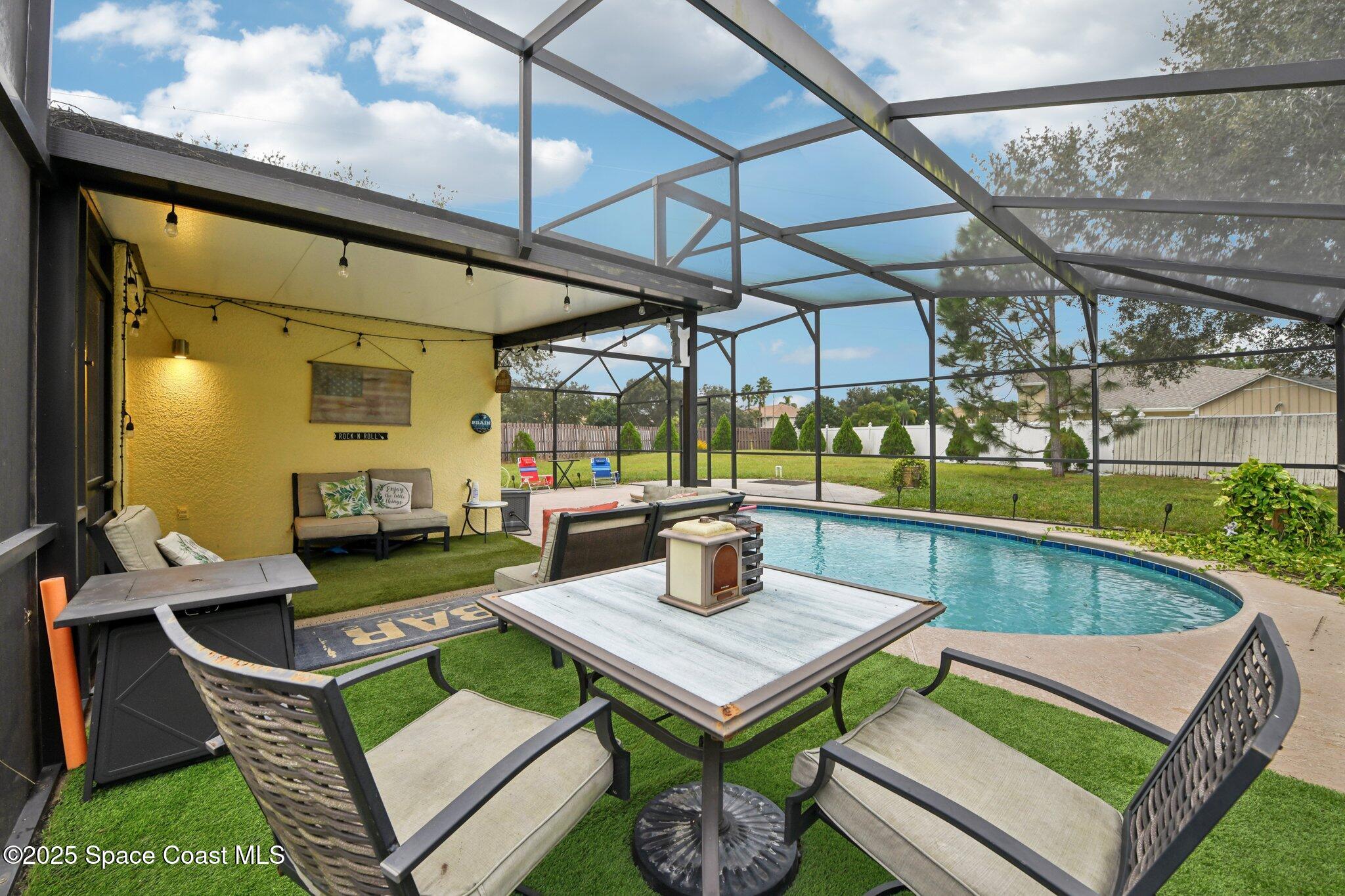 1125 Carey Glen Circle Orlando, FL 32824 - Photo 22 of 31 a view of a patio with table and chairs and potted plants