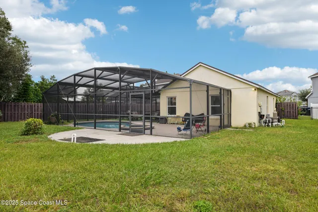 a view of a house with backyard sitting area and garden