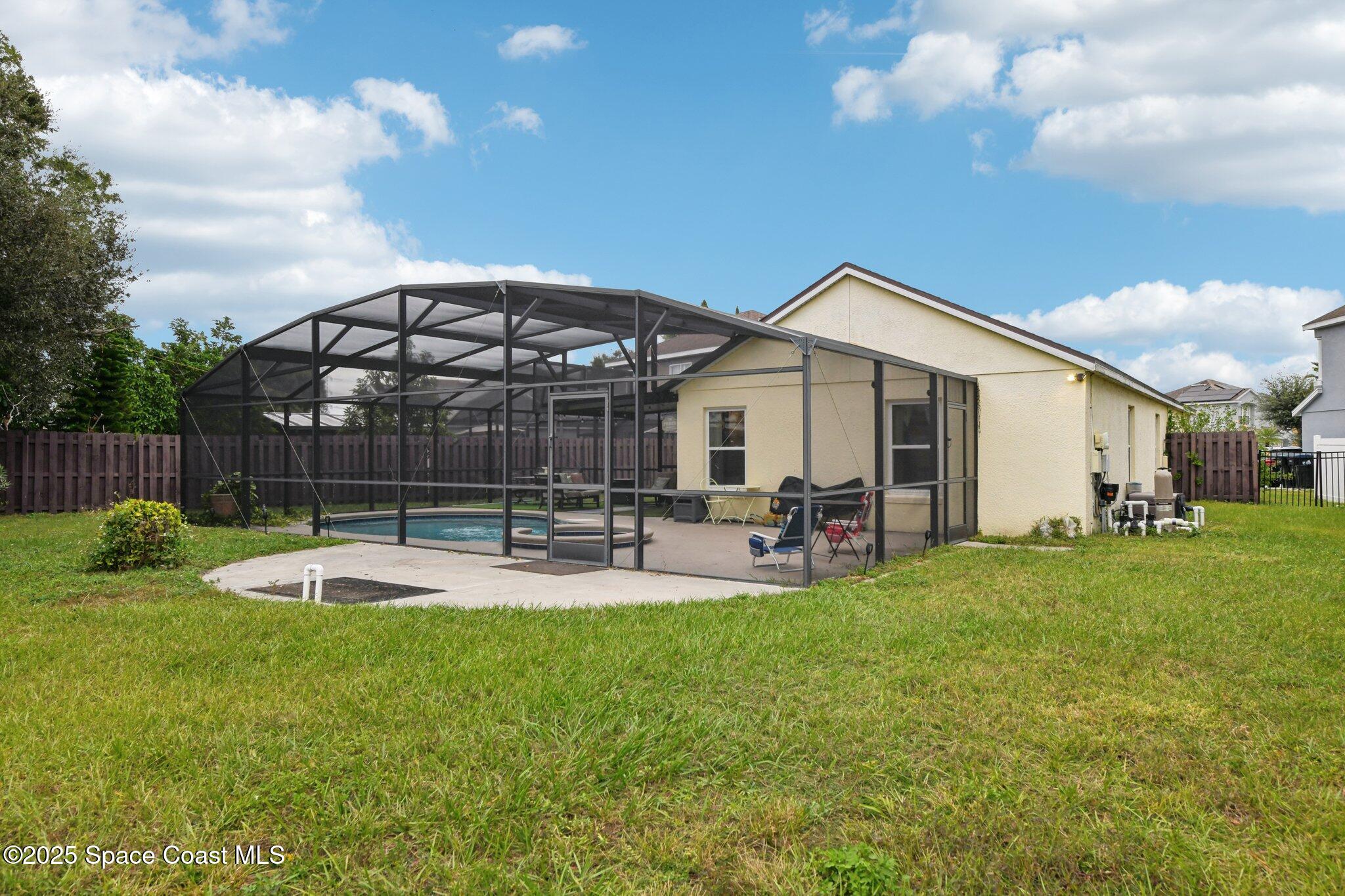 1125 Carey Glen Circle Orlando, FL 32824 - Photo 27 of 31 a view of a house with backyard sitting area and garden