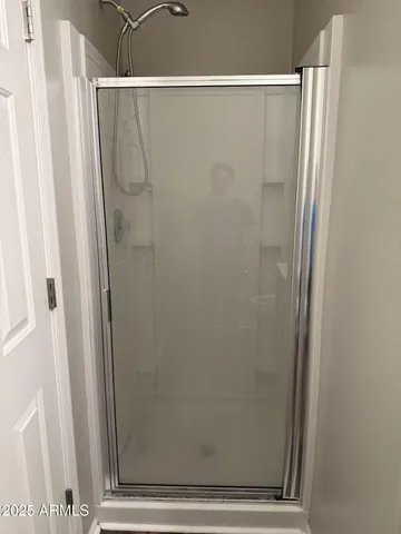 a bathroom with a glass shower door