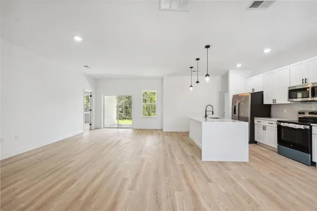 a view of kitchen with furniture and wooden floor