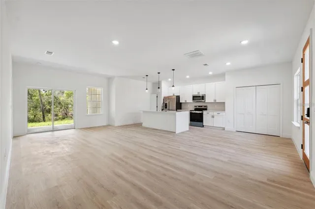 a view of kitchen with furniture and refrigerator