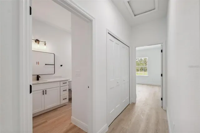 a view of a hallway with wooden floor