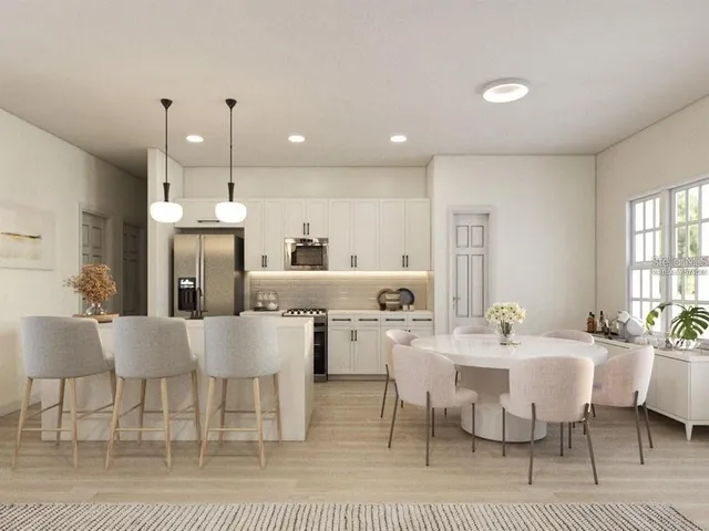 a large kitchen with a table and chairs