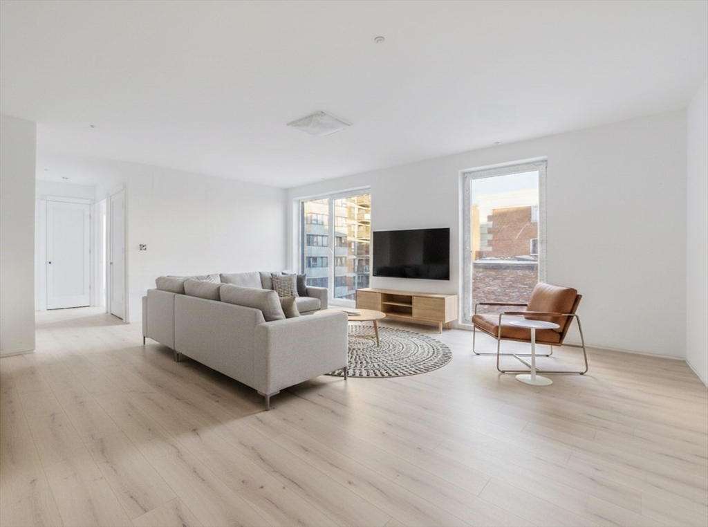 1035 Commonwealth Avenue, Unit 510 Boston, MA 02215 - Photo 2 of 16 a living room with furniture wooden floor and a flat screen tv