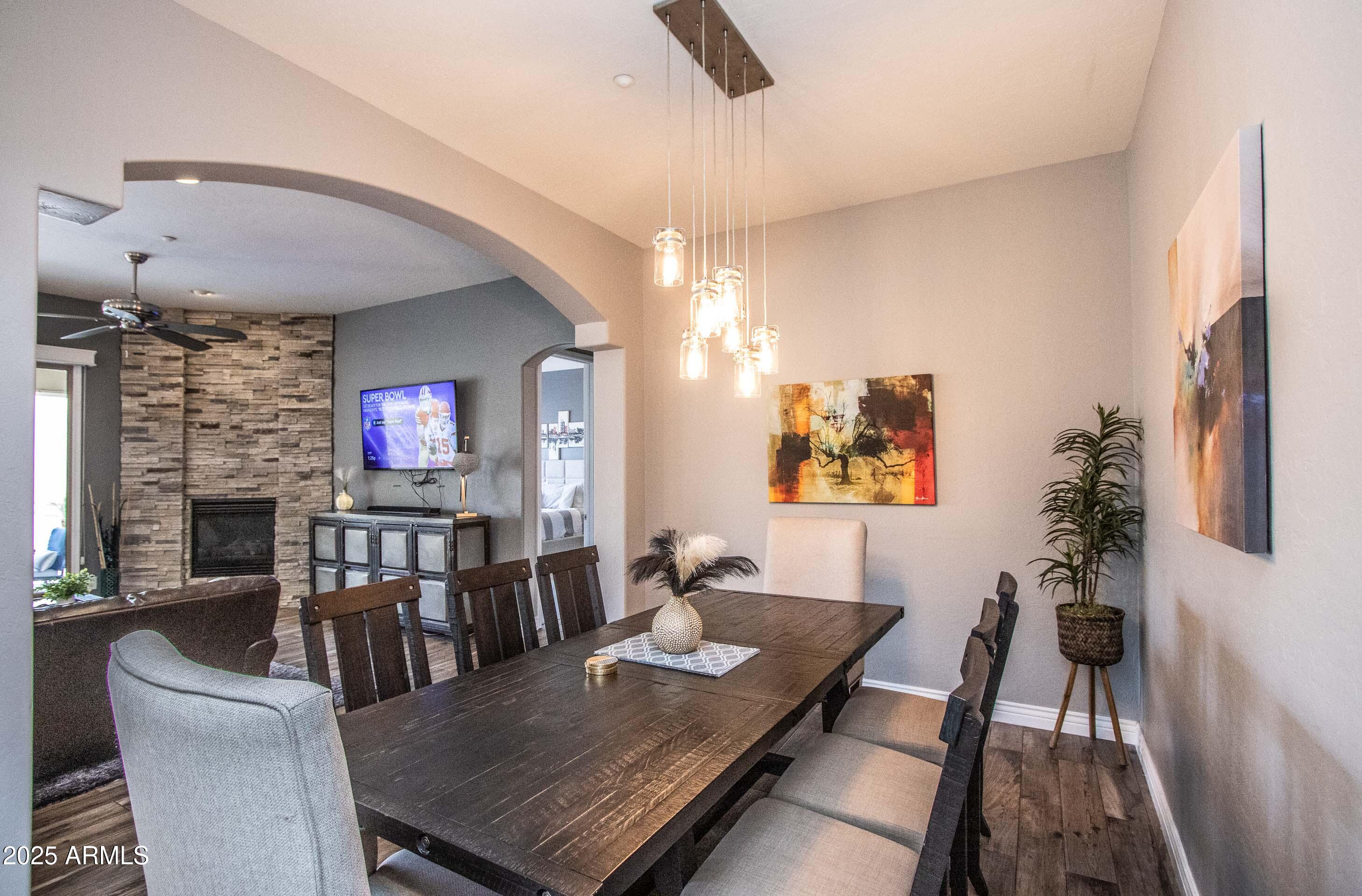 10412 East Acoma Drive Scottsdale, AZ 85255 - Photo 11 of 21 a living room with furniture a flat screen tv and a fireplace