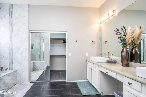 a bathroom with a double vanity sink a mirror and a shower
