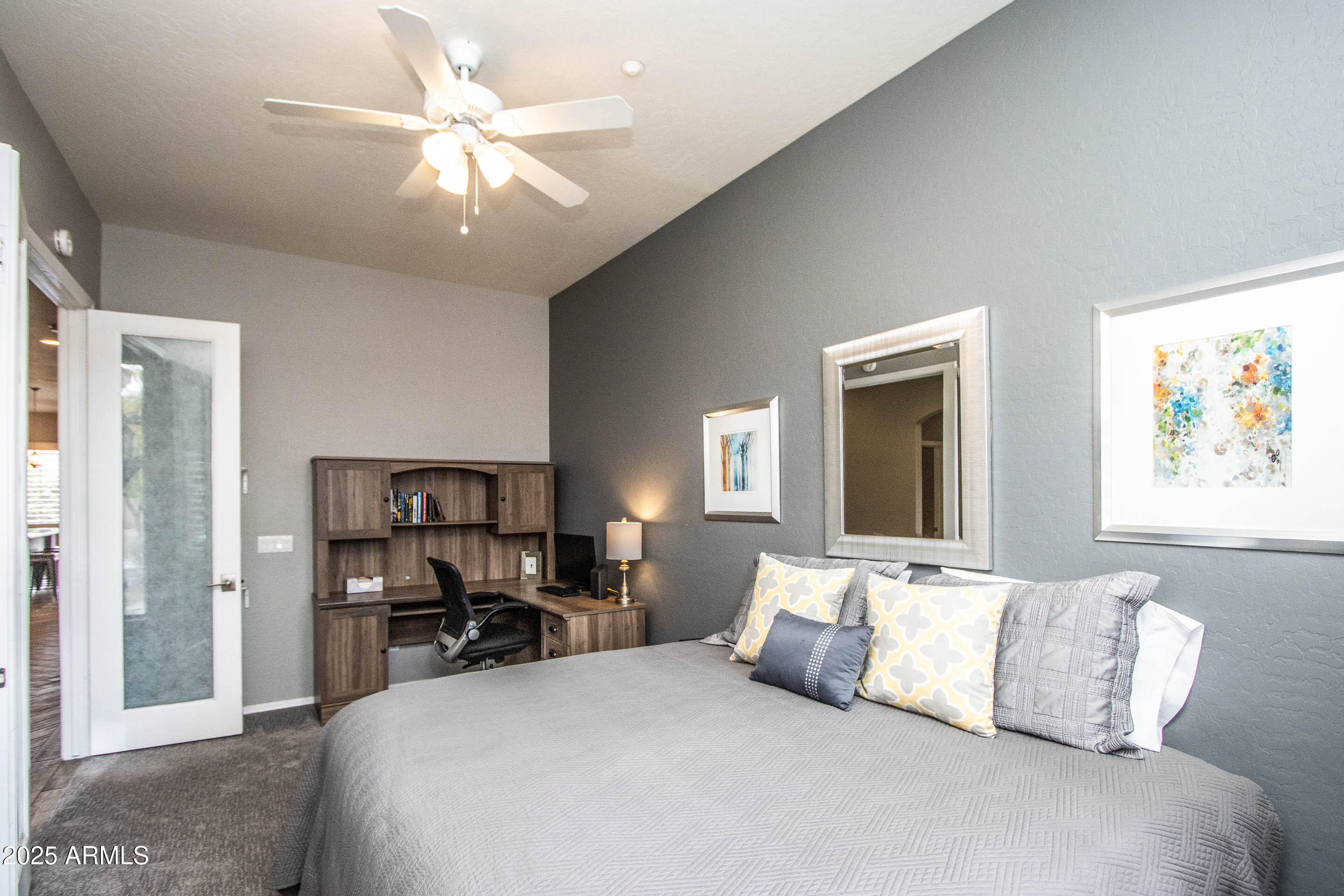10412 East Acoma Drive Scottsdale, AZ 85255 - Photo 15 of 21 a bedroom with a large bed and a chandelier