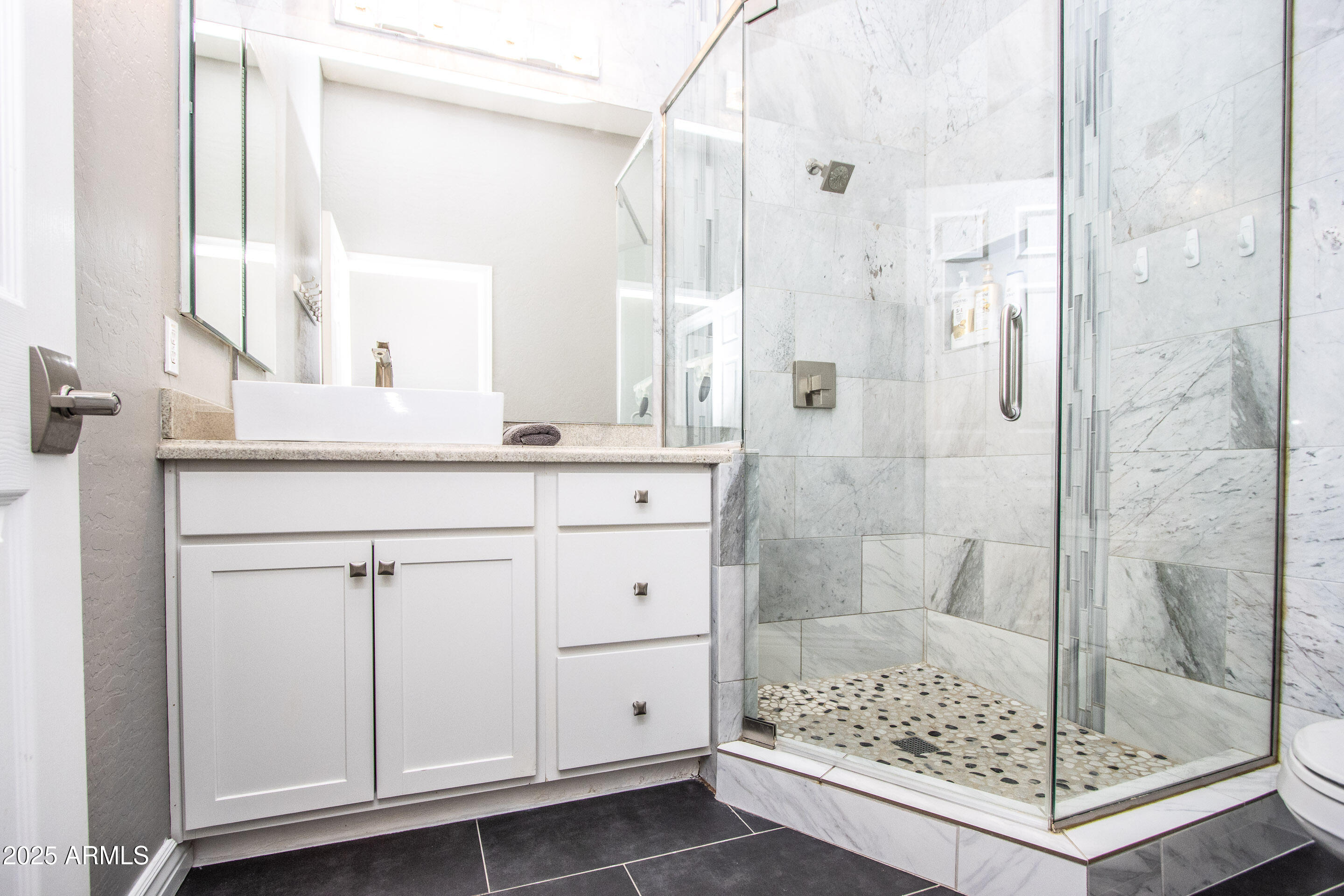 10412 East Acoma Drive Scottsdale, AZ 85255 - Photo 16 of 21 a bathroom with a shower and a sink a mirror