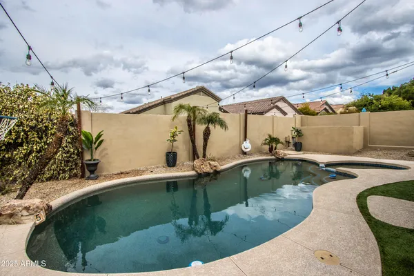 a view of a swimming pool with a yard