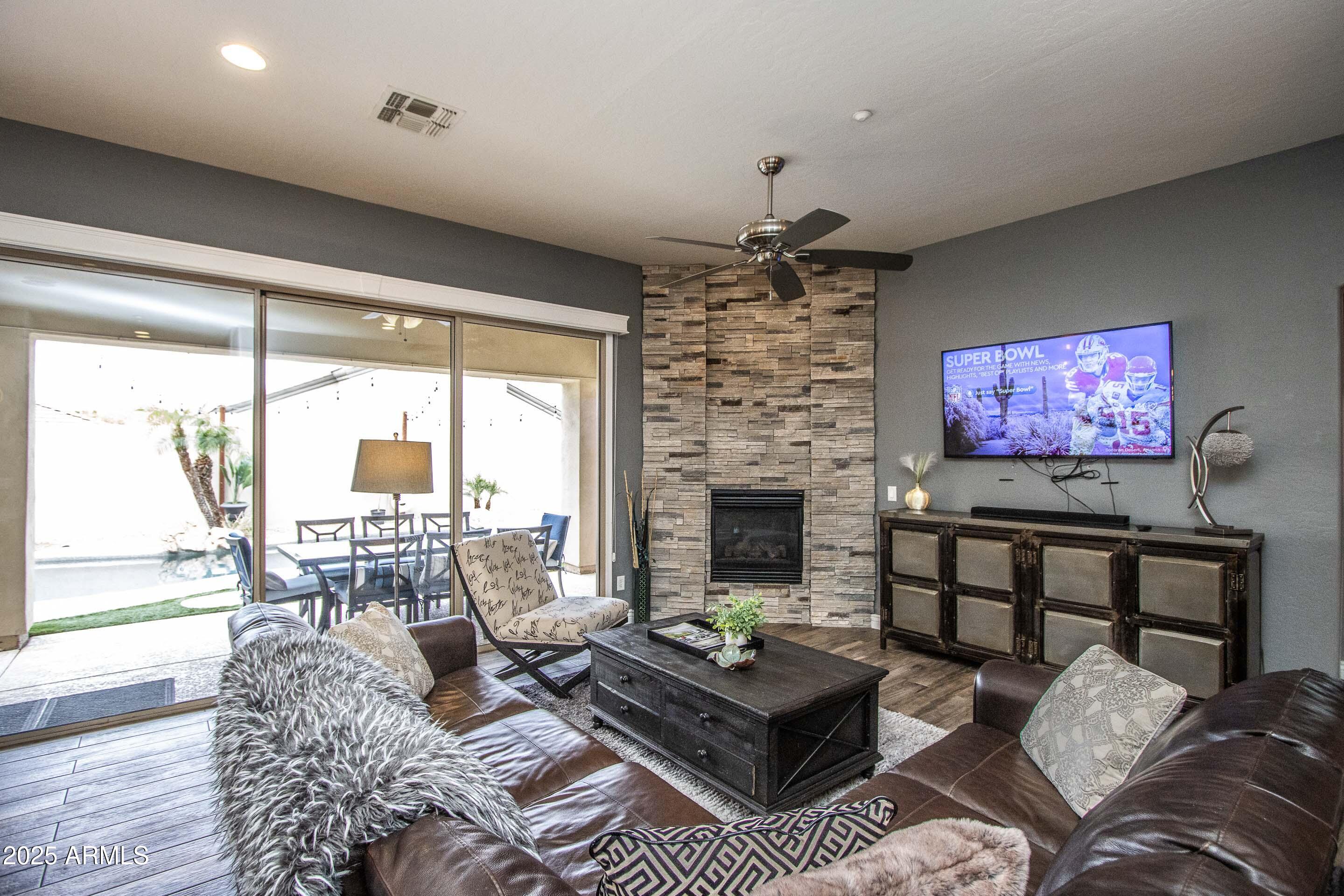 10412 East Acoma Drive Scottsdale, AZ 85255 - Photo 9 of 21 a living room with furniture a flat screen tv and a large window