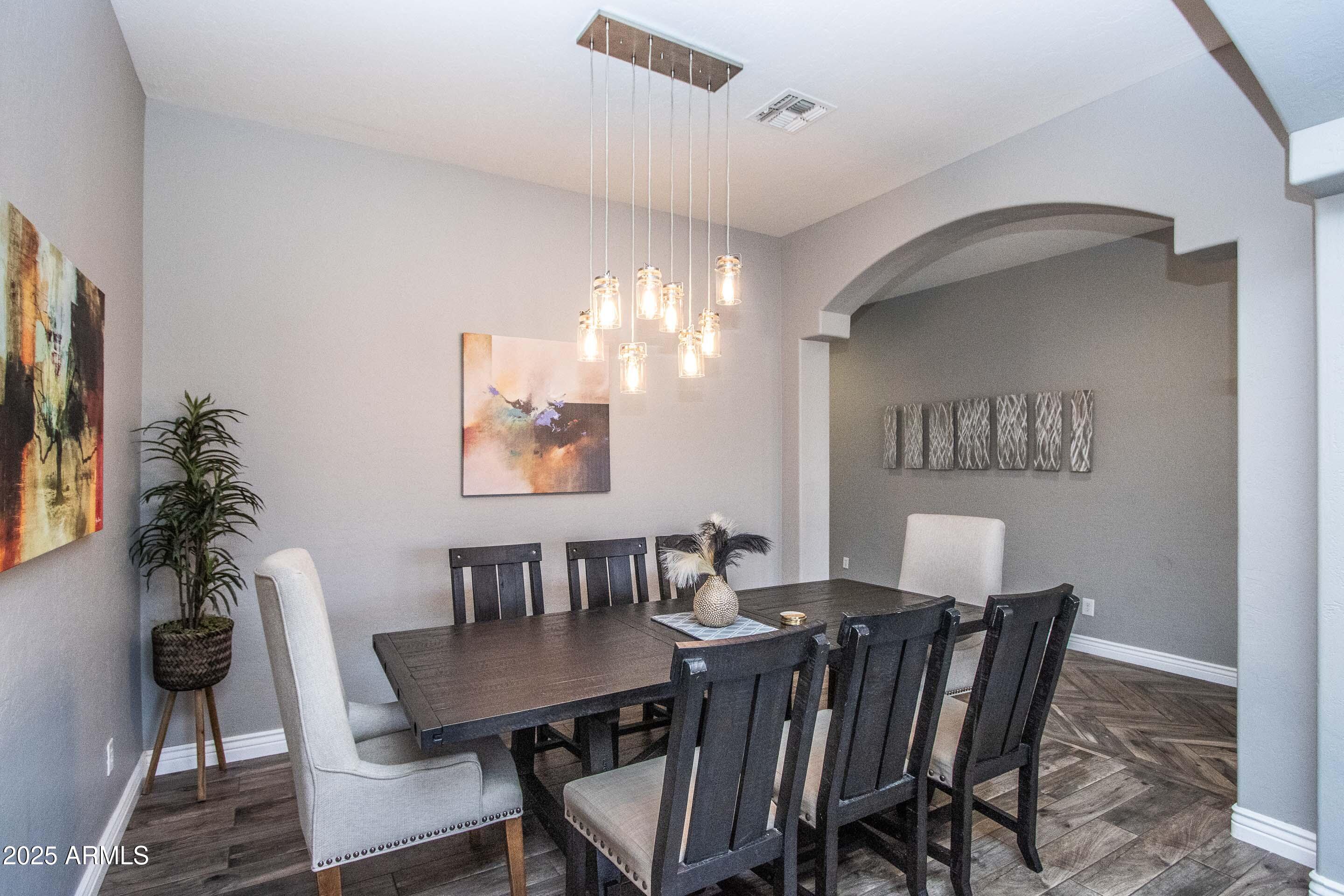 10412 East Acoma Drive Scottsdale, AZ 85255 - Photo 10 of 21 a view of a dining room with furniture and wooden floor