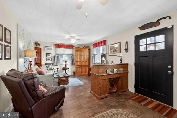 a living room with furniture windows and a flat screen tv