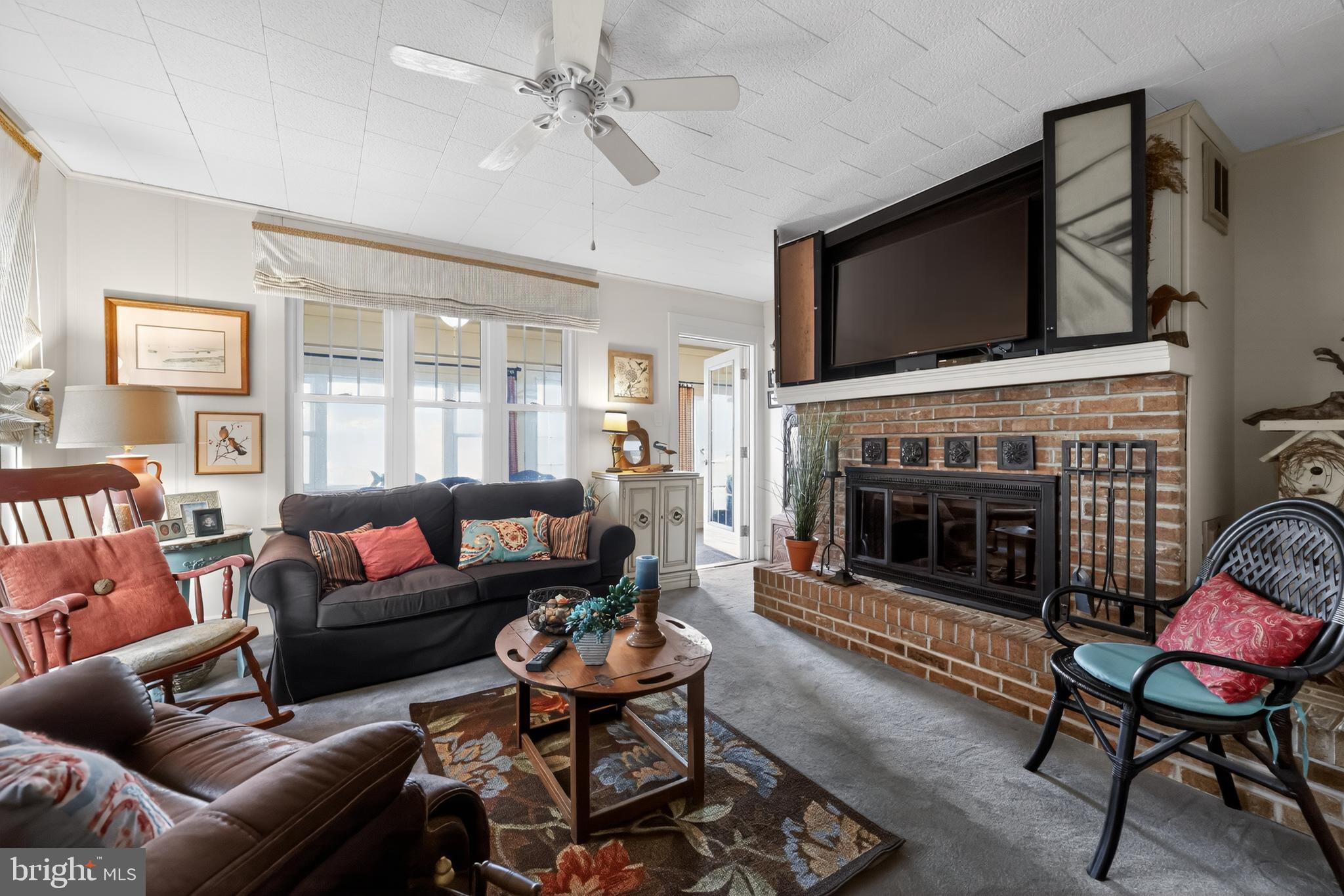 723 Salem Fort Elfsborg Road Salem, NJ 08079 - Photo 20 of 51 a living room with furniture a flat screen tv and a fireplace