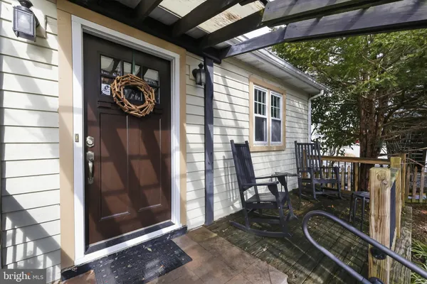 a view of a porch with furniture and front door