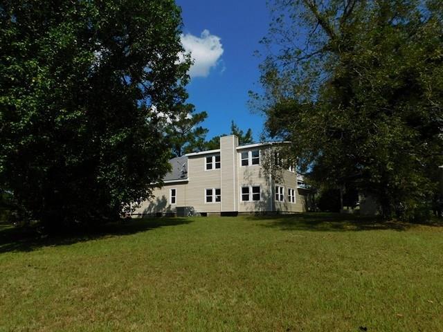 1241 Zenith Mill Road Roberta, GA 31078 - Photo 27 of 31 a white house with a big yard and large trees