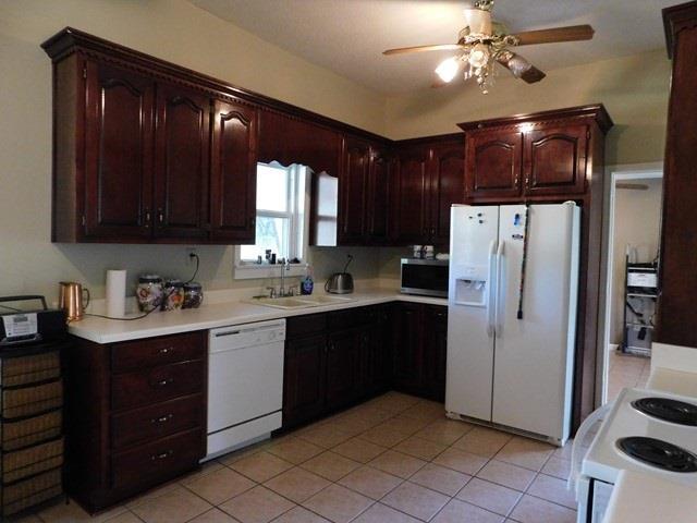 1241 Zenith Mill Road Roberta, GA 31078 - Photo 4 of 31 a kitchen with kitchen island granite countertop cabinets and refrigerator