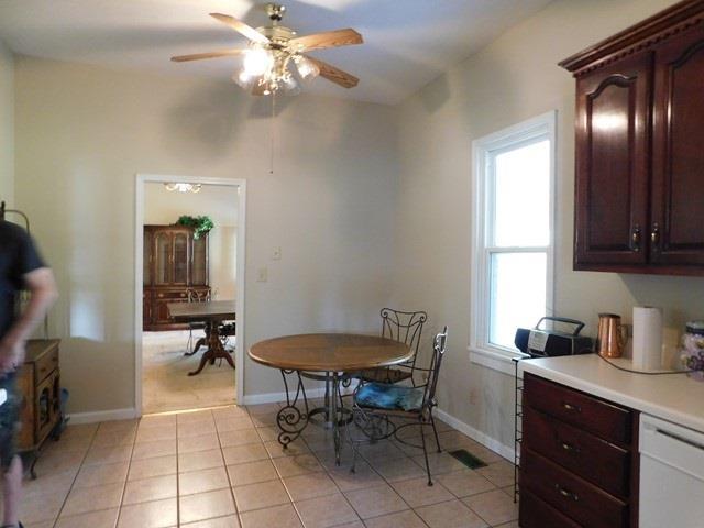 1241 Zenith Mill Road Roberta, GA 31078 - Photo 5 of 31 a kitchen with a table chairs and a refrigerator