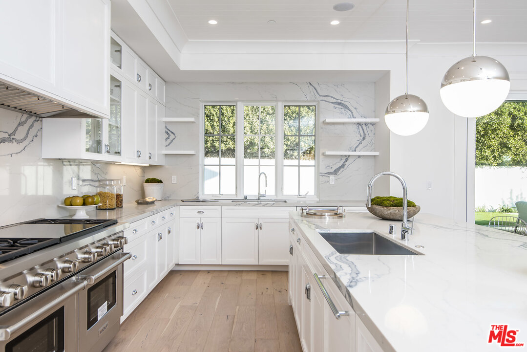 107 Larkin Place Santa Monica, CA 90402 - Photo 17 of 51 a kitchen with stainless steel appliances a sink a stove and cabinets