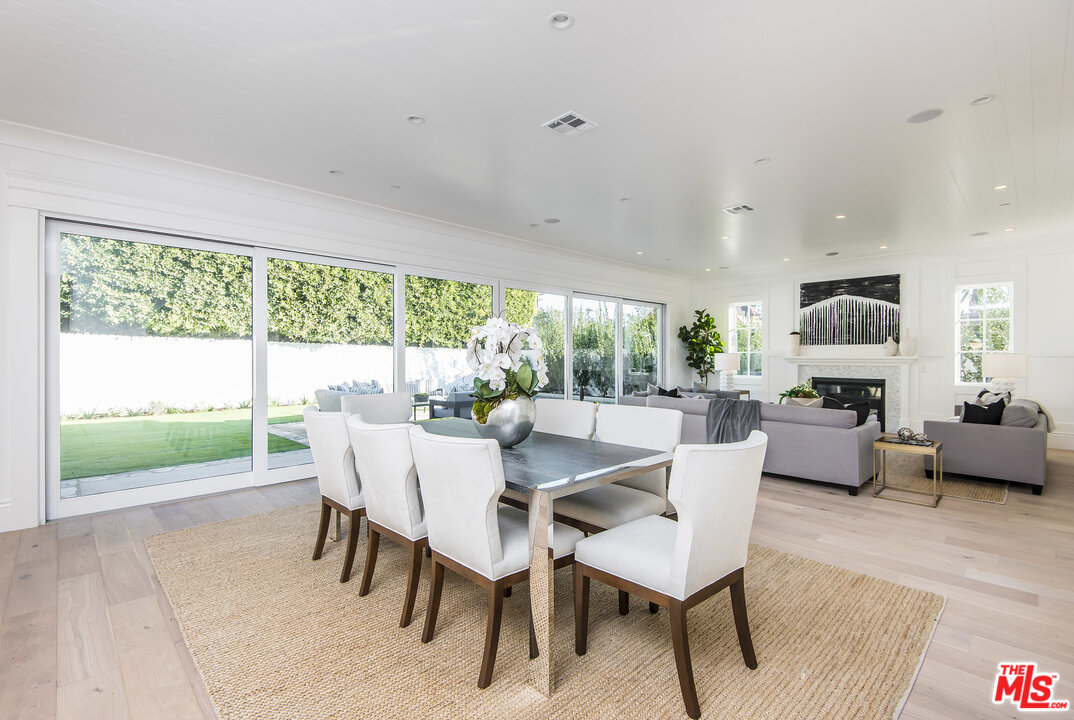 107 Larkin Place Santa Monica, CA 90402 - Photo 21 of 51 a dining room with furniture a fireplace and wooden floor