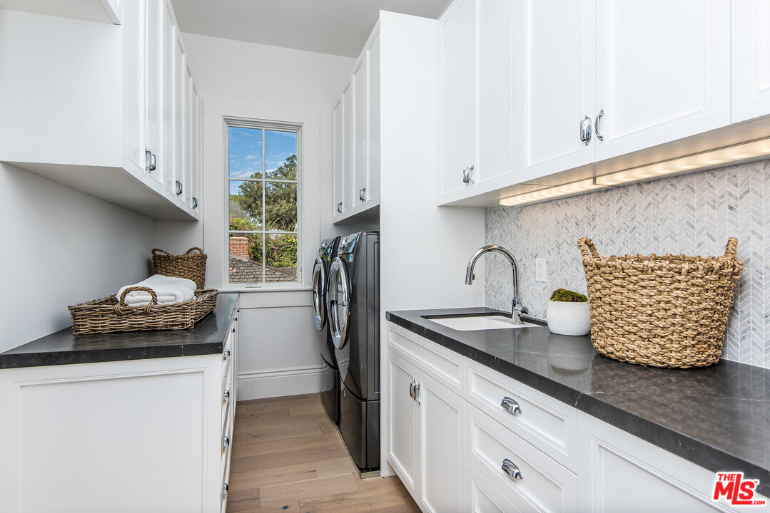 107 Larkin Place Santa Monica, CA 90402 - Photo 40 of 51 a kitchen with stainless steel appliances granite countertop a sink dishwasher and a refrigerator