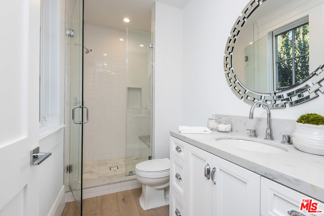 107 Larkin Place Santa Monica, CA 90402 - Photo 47 of 51 a bathroom with a granite countertop sink mirror vanity and toilet