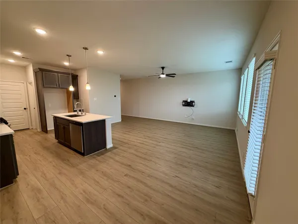 a view of a kitchen with a sink and a refrigerator
