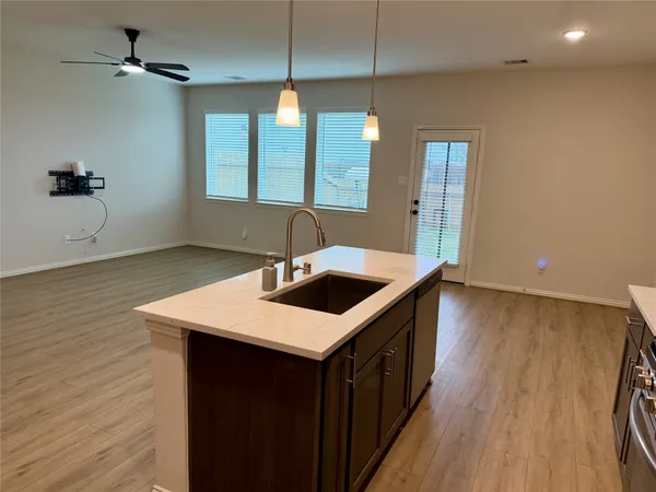 a kitchen with a sink stove and cabinets