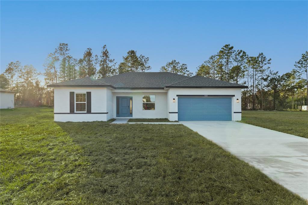 15136 Southwest 61st Court Road Ocala, FL 34473 - Photo 1 of 1 a front view of a house with garden