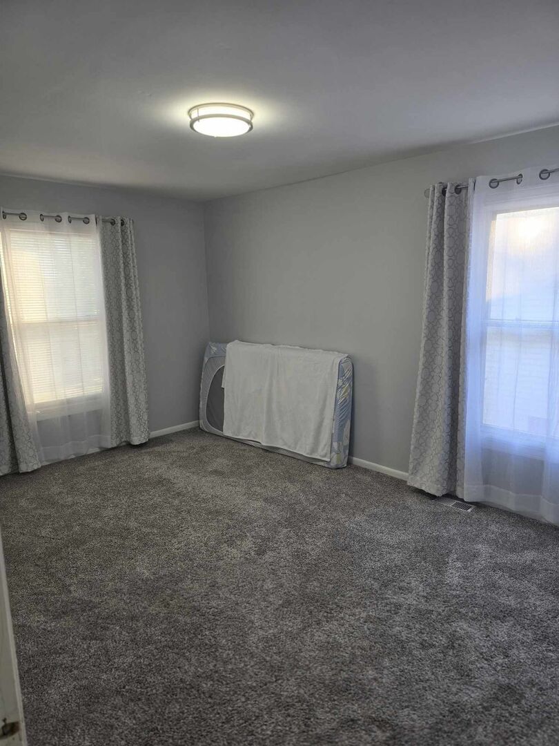 877 Wellington Avenue, Unit 1 Elk Grove Village, IL 60007 - Photo 12 of 25 an empty room with a fireplace