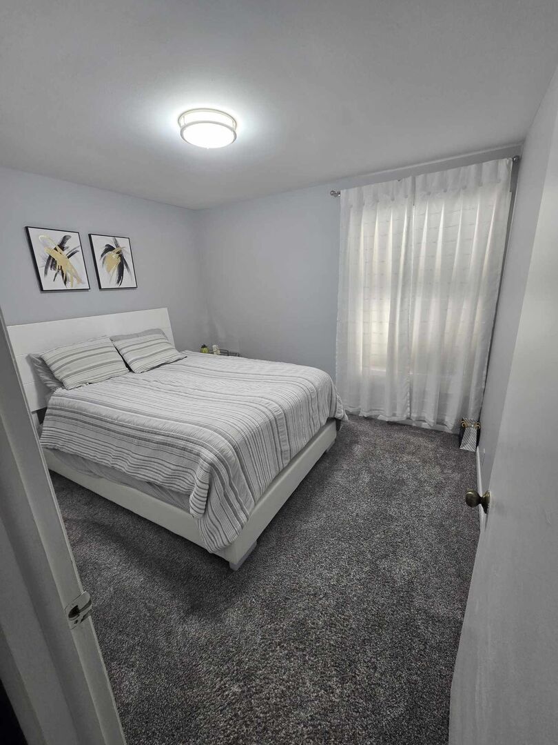 877 Wellington Avenue, Unit 1 Elk Grove Village, IL 60007 - Photo 13 of 25 a bedroom with a bed and a window