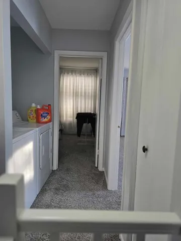 a view of a bedroom that has a bed and a window