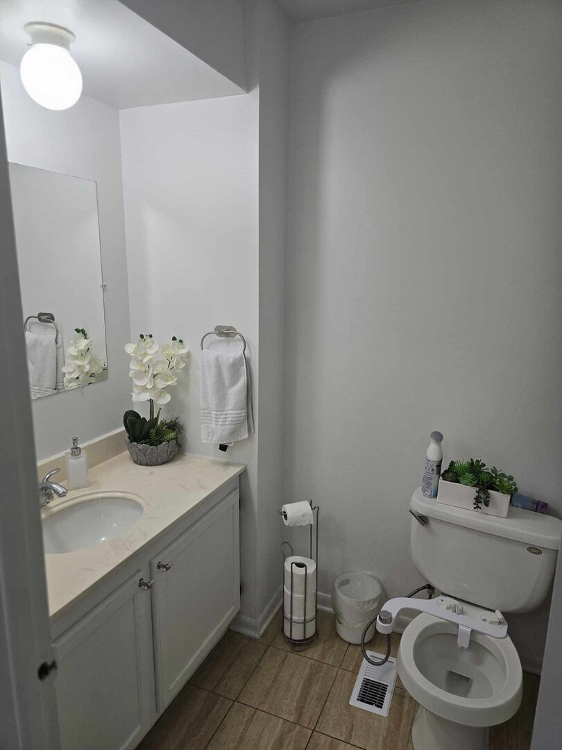 877 Wellington Avenue, Unit 1 Elk Grove Village, IL 60007 - Photo 19 of 25 a bathroom with a toilet sink and mirror
