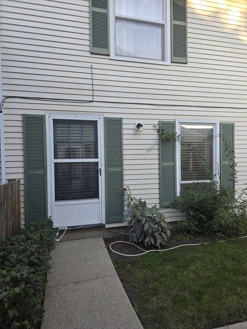 877 Wellington Avenue, Unit 1 Elk Grove Village, IL 60007 - Photo 3 of 25 a front view of a house with a garden and plants