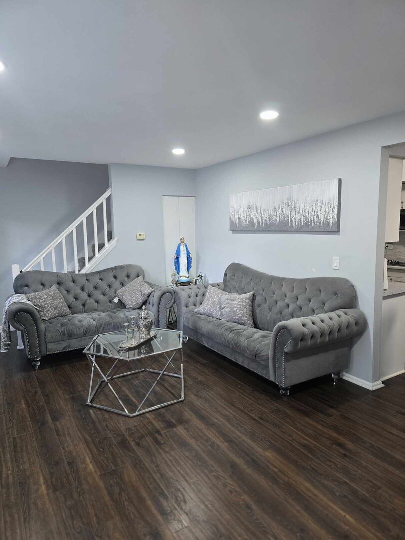 877 Wellington Avenue, Unit 1 Elk Grove Village, IL 60007 - Photo 5 of 25 a living room with furniture and a wooden floor