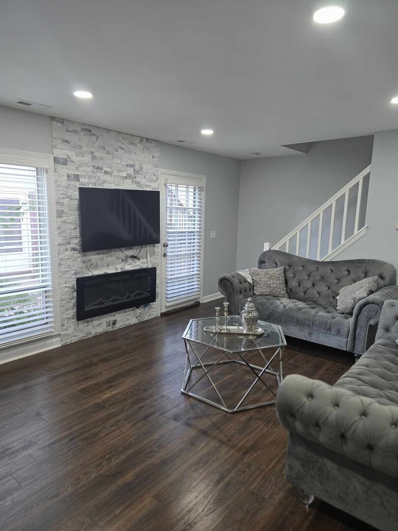 877 Wellington Avenue, Unit 1 Elk Grove Village, IL 60007 - Photo 7 of 25 a living room with furniture and a flat screen tv