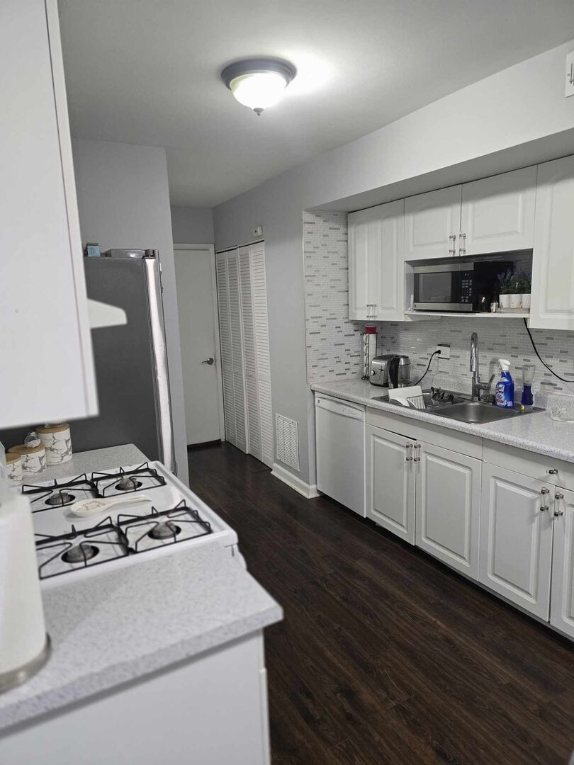 877 Wellington Avenue, Unit 1 Elk Grove Village, IL 60007 - Photo 9 of 25 a kitchen with sink a stove and refrigerator
