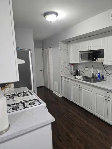 a kitchen with sink a stove and refrigerator