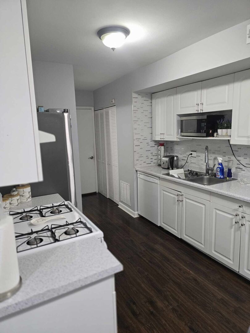 877 Wellington Avenue, Unit 1 Elk Grove Village, IL 60007 - Photo 10 of 25 a kitchen with sink a stove and refrigerator