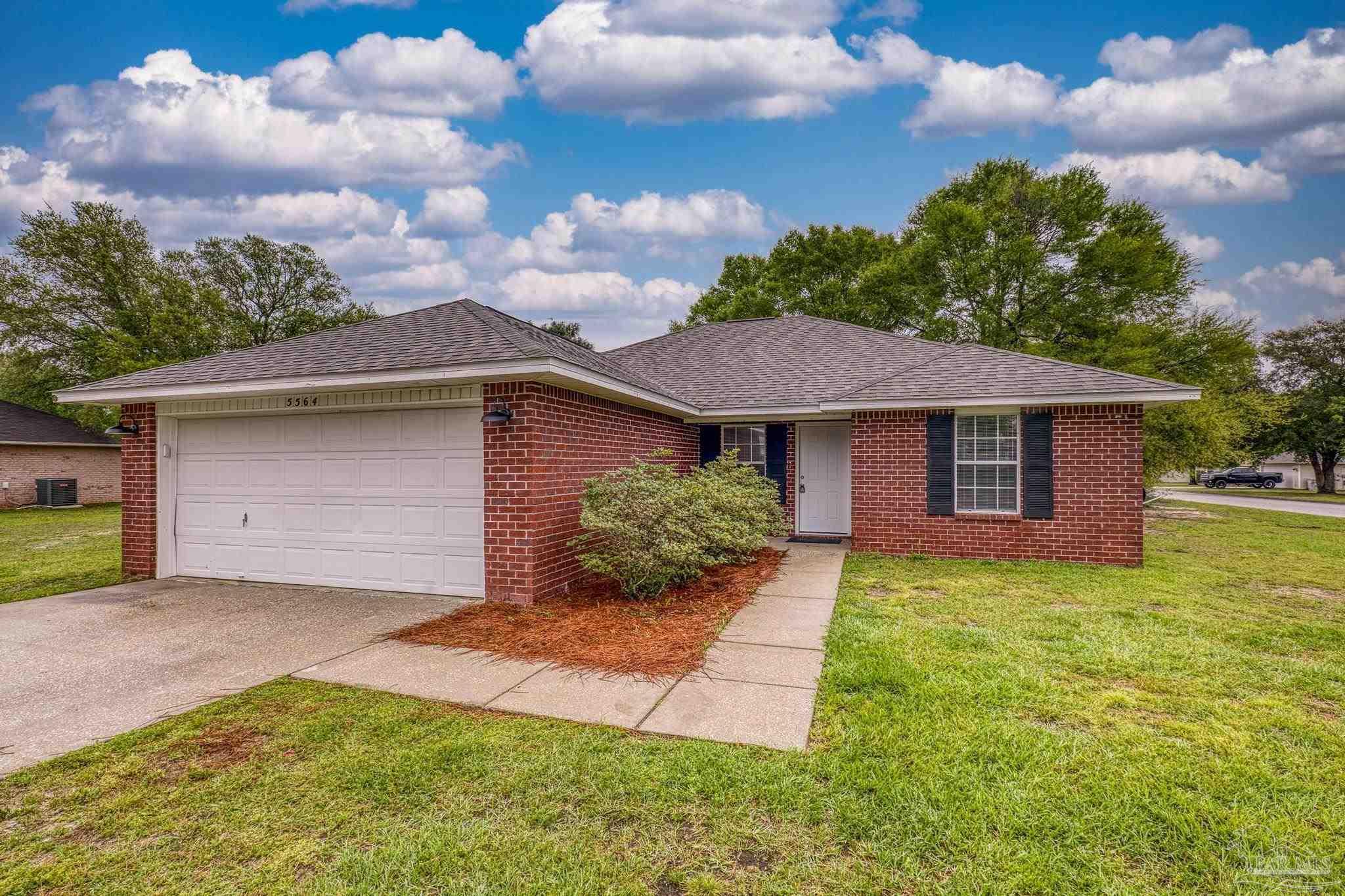 5564 Paddle Wheel Drive Milton, FL 32583 - Photo 1 of 41 a front view of a house with a yard and garage