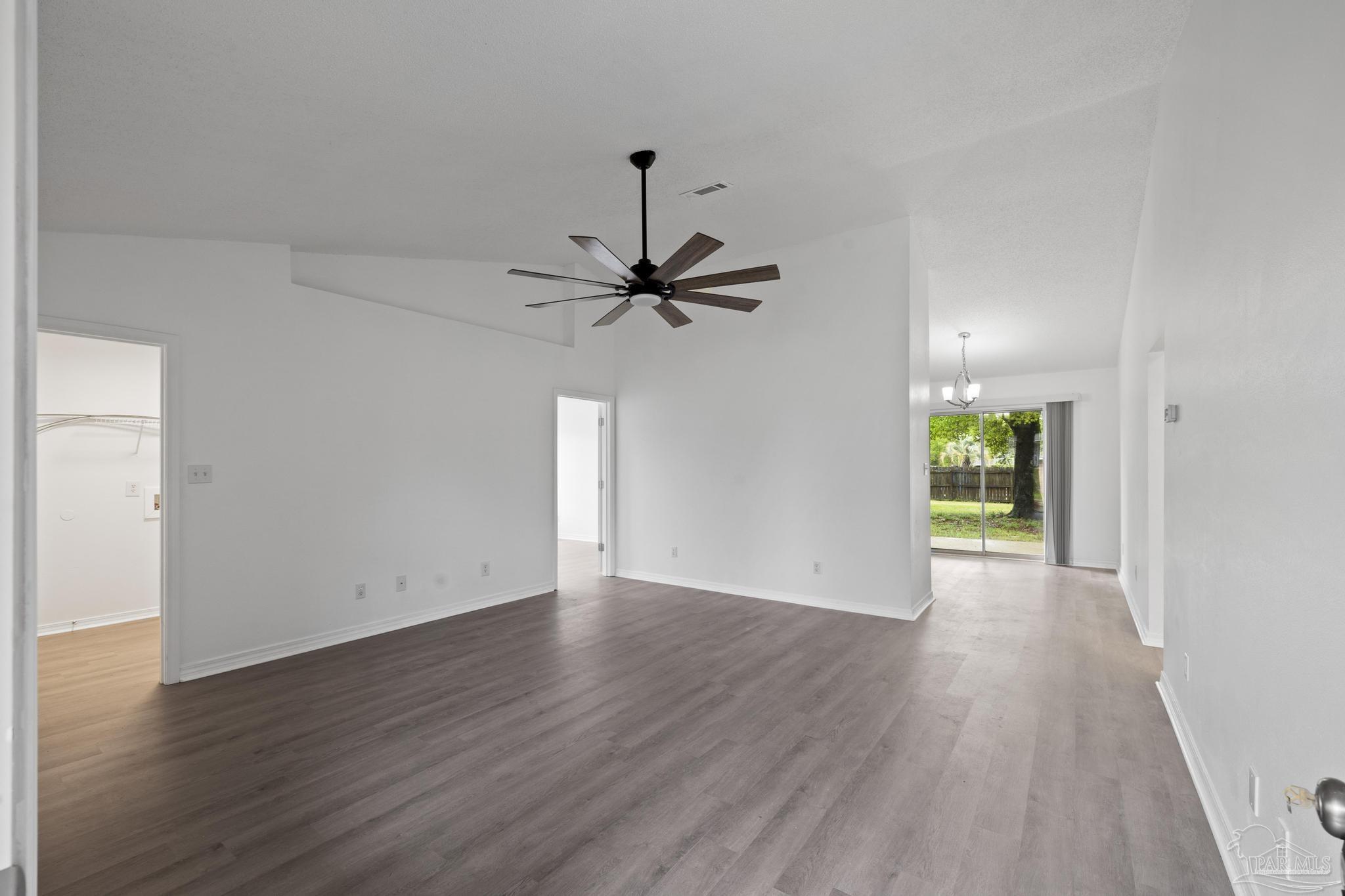 5564 Paddle Wheel Drive Milton, FL 32583 - Photo 13 of 41 a view of a room with wooden floor a ceiling fan and window