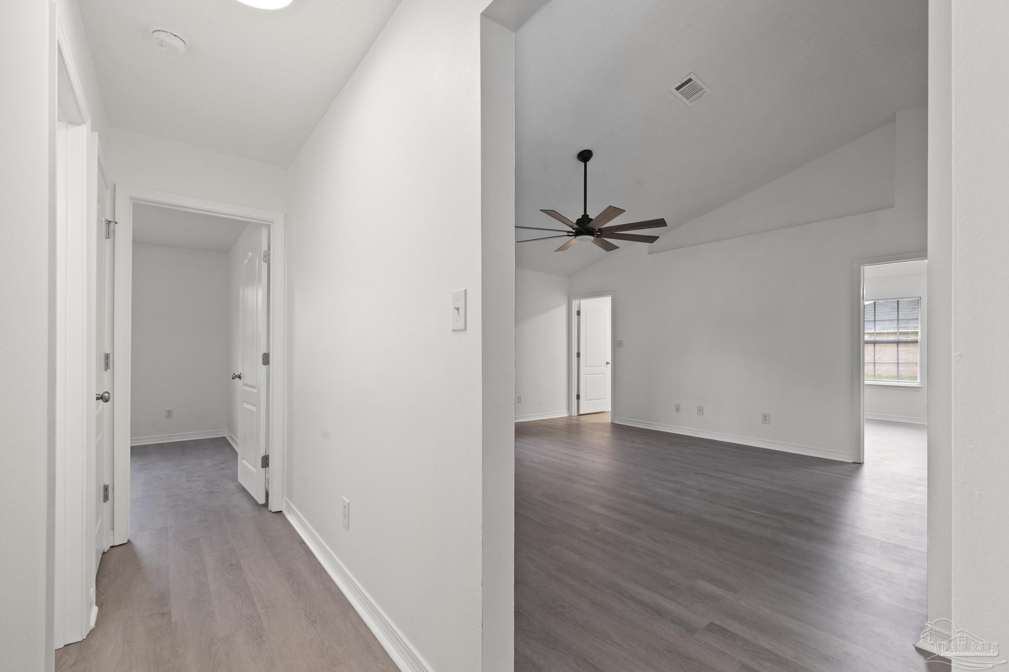 5564 Paddle Wheel Drive Milton, FL 32583 - Photo 17 of 41 a view of a hallway with wooden floor