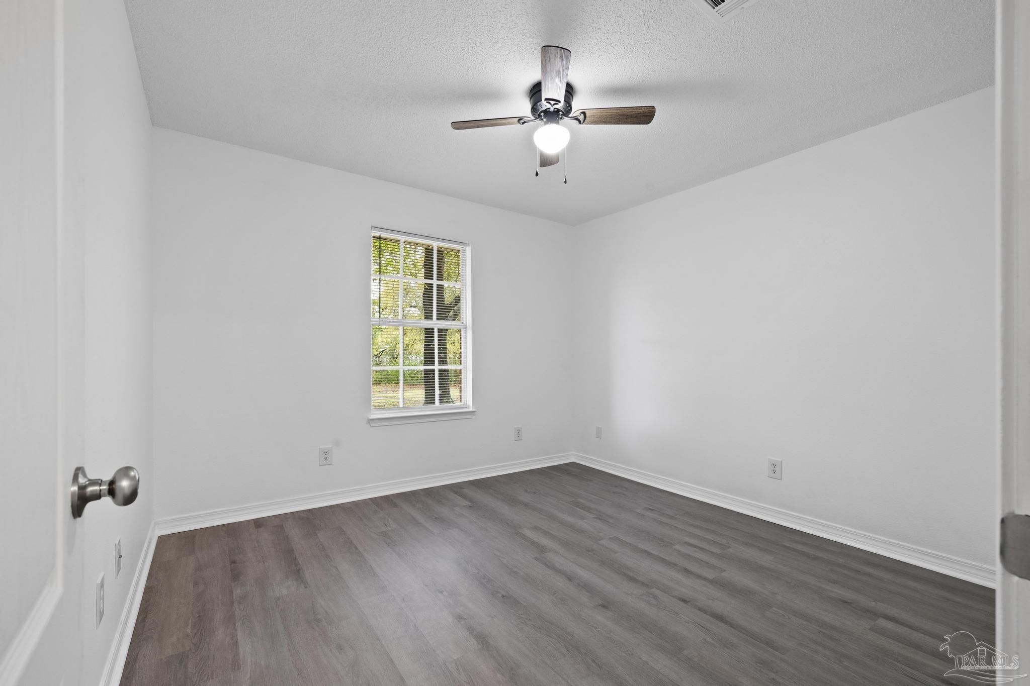 5564 Paddle Wheel Drive Milton, FL 32583 - Photo 18 of 41 wooden floor in an empty room with a window